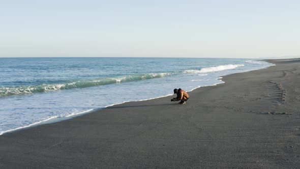 Aerial view of a photographer by the ocean