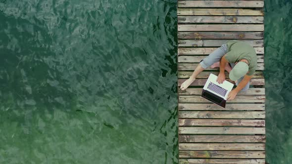 Men Working Online From Wooden Pier Aerial View