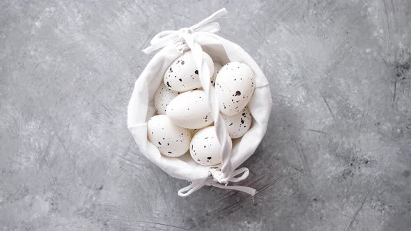 Composition of White Traditional Dotted Easter Eggs in White Wicker Basket