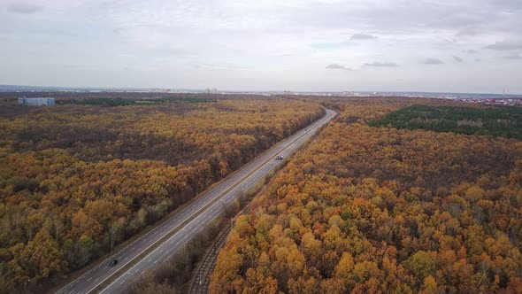 Aerial View of Road Between Forests in Countryside
