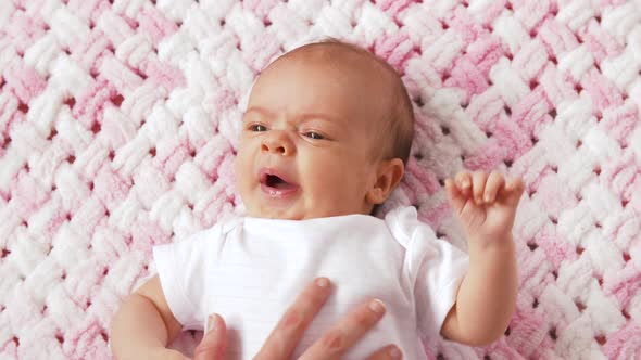Sweet Baby Girl Lying on Knitted Plush Blanket