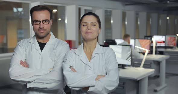 Cheerful Couple of Scientists in Technician Laboratory