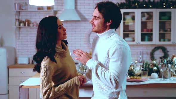 Happy couple celebrating christmas at home.