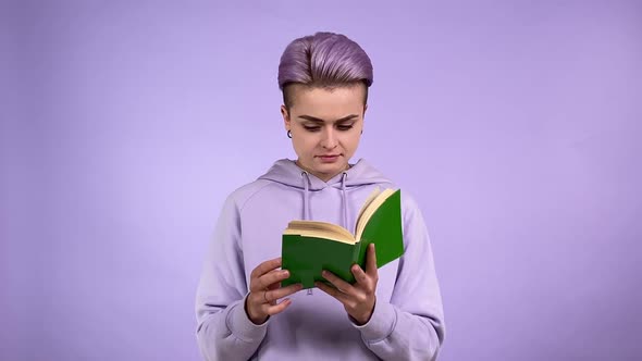 Female Student Turning Pages of Book Passionate About Story Indoors