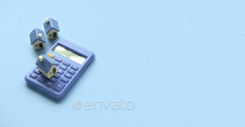  rate. Saving for house.Miniature house with calculator over blue background with copy space.