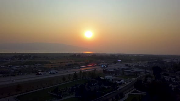 Beautiful aerial red sunset in a smoggy sky from summer wildfires. View of the sunset with mountains