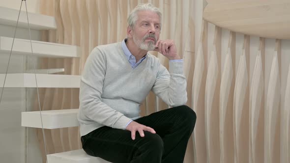 Relaxing Pensive Old Man Sitting on Staircase