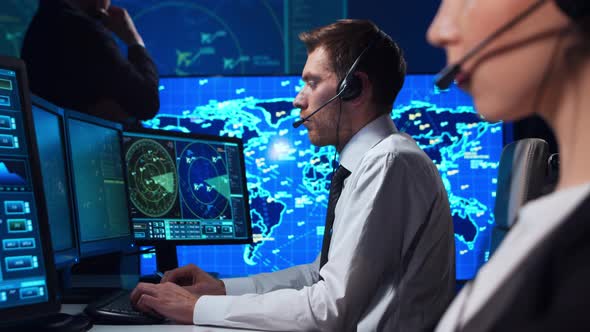 Workplace of the air traffic controllers in the control tower. Team of professional officers.