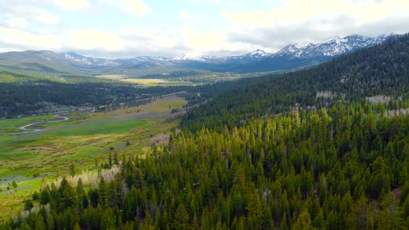 Aerial View Flight Over Picturesque Landscape of Snowcapped Alpine Mountains on the Horizon