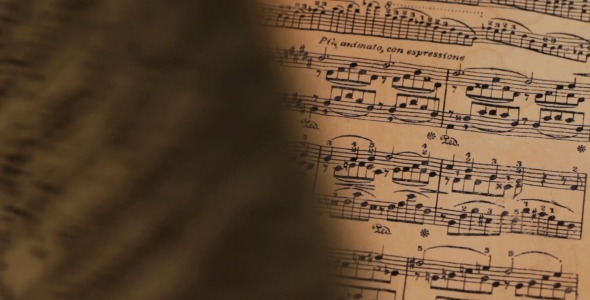 Turning Pages of Vintage Sheet Music
