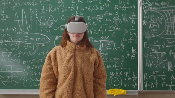 Portrait of Young Female Student Wearing Virtual Reality Headset in School Classroom