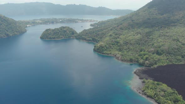 Aerial: flying over Banda Islands active volcano Gunung Api lava flow Indonesia 