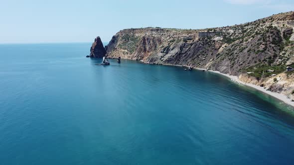 Aerial View From Above on Azure Sea and Volcanic Rocky Shores