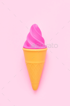 Pink toy ice-cream on a pink background. Minimalism, summer concept. Top view, copy space