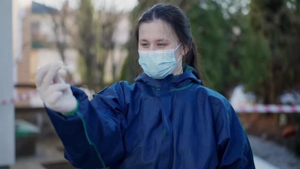 Portrait of Confident Intelligent Forensics Scientist Examining Ampoule with Poison Outdoors on