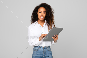 African American lady using her tablet computer for business, studio