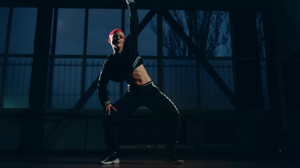 Sporty Woman Dancing Hip Hop in Dark Class