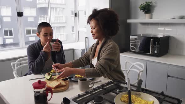 Lesbian couple having breakfast in kitchen