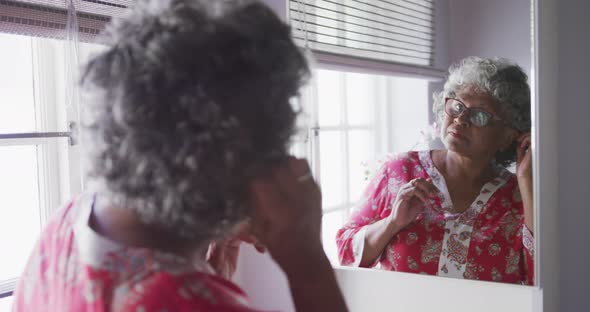 A senior african american woman spending time at home taking care of herself social distancing 