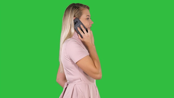 Young lady having call on a Green Screen, Chroma Key.