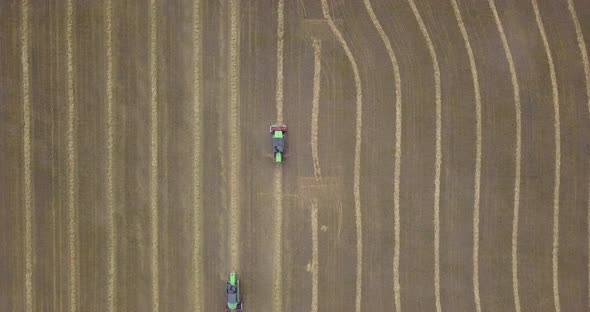 Two harvesters are moving towards each other