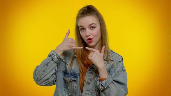 Teenager Girl in Denim Jacket Looking at Camera Doing Phone Gesture Like Says Hey you Call Me Back