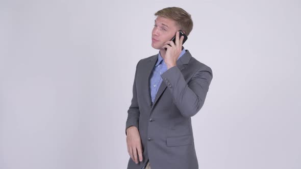 Happy Young Handsome Businessman Talking on the Phone