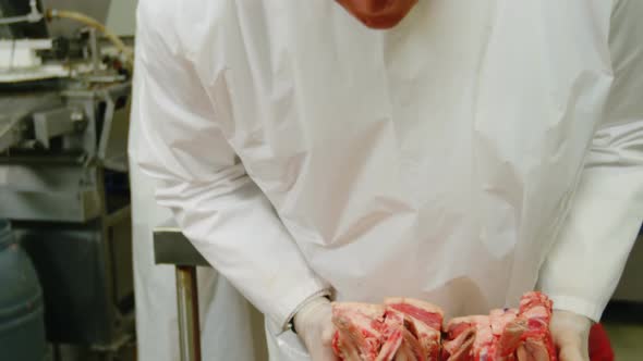Butcher arranging sliced red meat