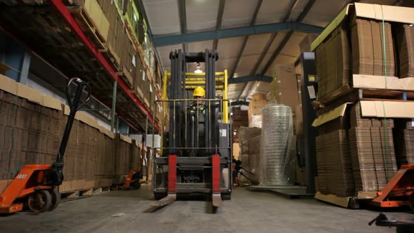 Delivery man moving packages in warehouse