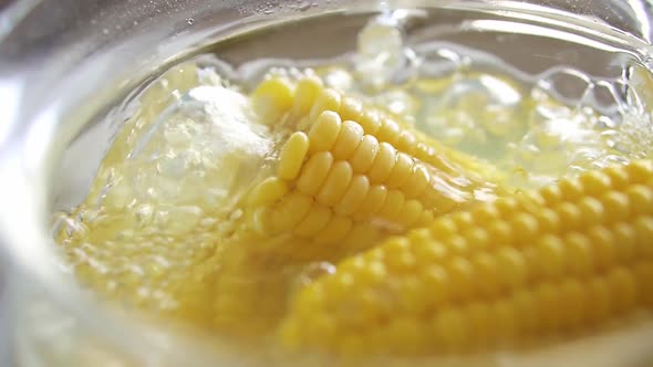 Close Up Sweet Yellow Corn Boiled In Water. Cooking Young Corncobs In Hot Water. The Corn Is Boiled