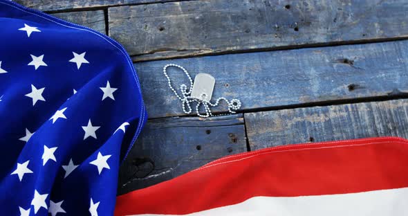 American flag and dog tag on a wooden table