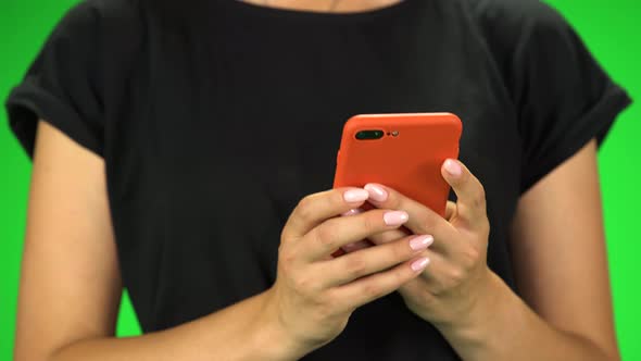 Girl Holding Red Phone in Her Hands While Walking, Close Up. Green Screen