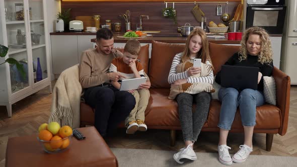 Busy on Gadgets Deaf People Relaxing on Sofa