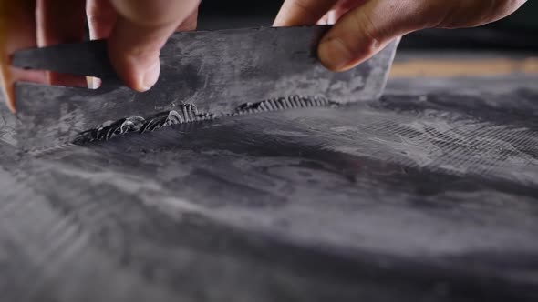 A Close-up of a Man's Hand with a Tool. A Professional Removes the Form From the Clay with the Help