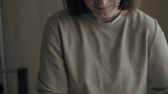 Woman Ironing Clothes At Home