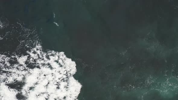 Aerial top view of rocks in the sea - Aerial video of majestic waves splashin