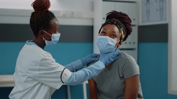 African American Medic Doing Examination on Young Patient