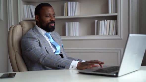 Afro-american Businessman Is Negotiating By Video Chat Online on Laptop in His Office, Communication