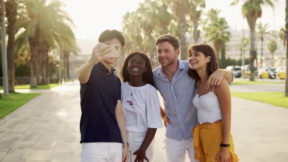 Happy Diverse Young People Making Call to Friends By Smartphone During Summer Vacation on Seaside