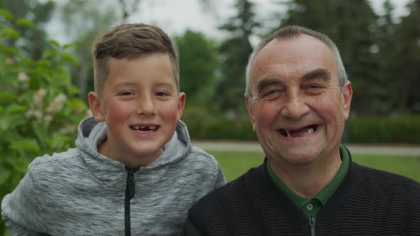 Toothless Grandfather and Grandson Are Laughing. Closeup.