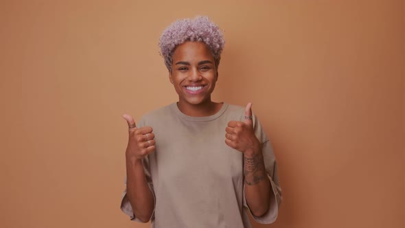 Portrait of Beautiful Young African Woman Smiling with Thumbs Up Hand Gesture