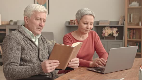 Woman Typing on Laptop with Husband with Parkinsons