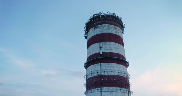 Aerial view on the top of a chimney, camera moving around right.