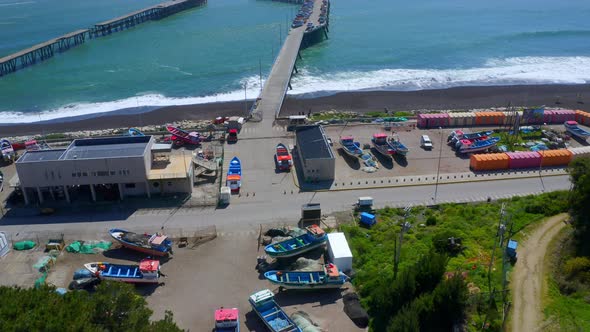 port or caleta meguellines, constitucion chile drone shot sunny day with fishing boats drone reveal
