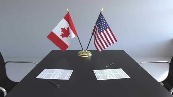 Flags of Canada and the United States on the Table