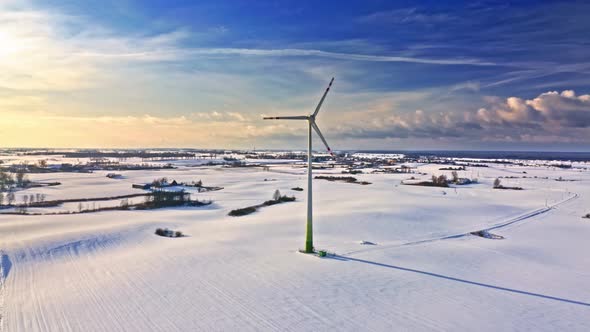 Wind turbine on snowy field. Alternative energy. Green energy.