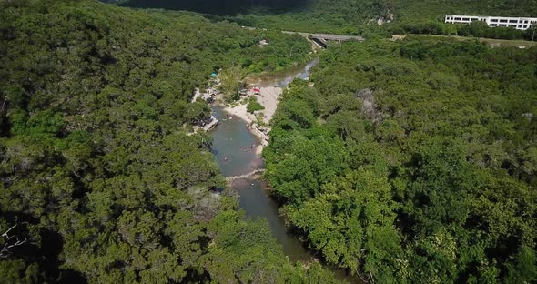 Aerial drone shot of the swimming hole at the Bull Creek Greenbelt in Austin, Texas.