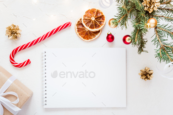 Empty Notebook with wish list and christmas festive decorations on white background