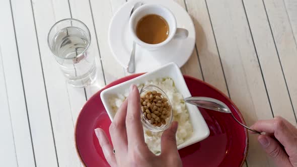 Cup with Rice on a White Wooden Background. Breakfast of Rice Porridge. Porridge in a Red Tarek on a