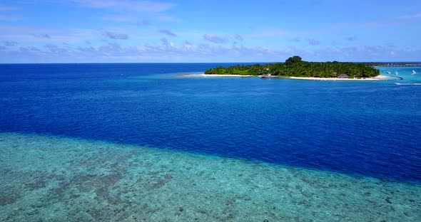 Natural flying abstract view of a summer white paradise sand beach and blue sea background in colorf